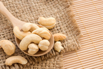 Close up cashews in wooden spoon