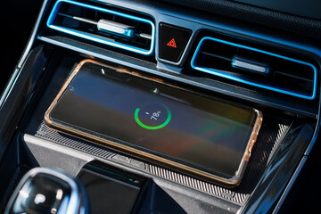 Wireless mobile charger in the modern car. Portable wireless car charger for smartphone.	
