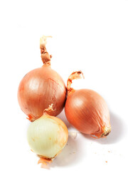 Pile of brown color organic onion and on white surface. Worldwide popular product and food ingredient. Garden vegetable.