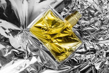 Perfume on foil background