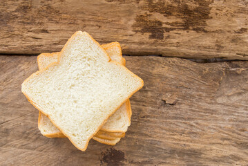Slice of bread on wooden table background