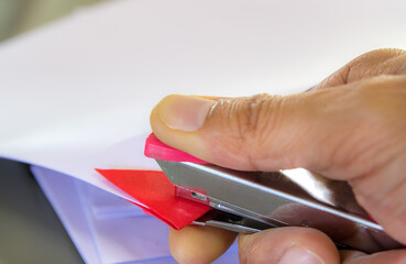 Hands with papers and stapler