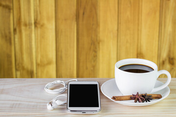 Obraz premium Smart phone and coffee on wooden table