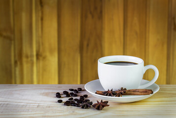 coffee cup and coffee beans on wooden table