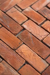 Detailed close-up of a weathered brick floor, showcasing the texture and pattern of the bricks