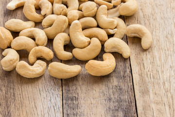 Cashew nuts scattered on a wooden table