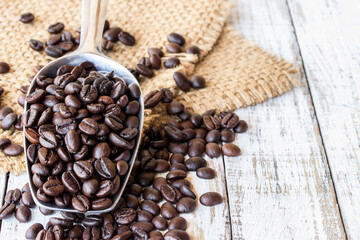 Big stainless steel scoop of coffee beans