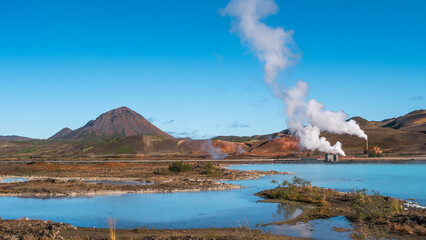 Panoramic view over geothermal active zones with power plants in Iceland, near Myvatn lake, summer and blue sky