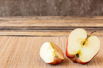 Slice half red apple on old wooden table