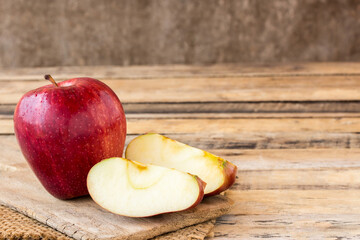 Slice red apple on old wooden table