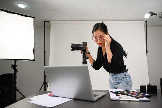 Beautiful creative female freelancer working at modern photography studio