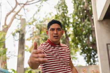 Belligerent Asian man confronting trespasser on his property, point of view shot