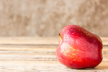 fresh red apple on wooden table