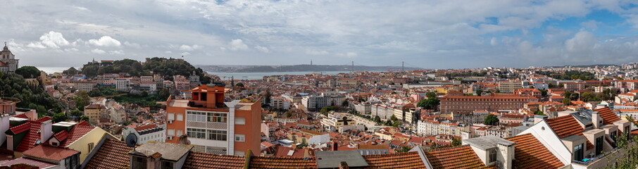 Panoramic view of the cityscape of Lisbon, Portugal, with Sao Jorge Castle and the red roofes of the Alfama district - 765520076
