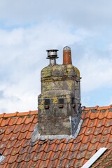 chimney on a roof with clay tiles