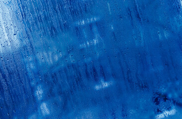 blue abstract wet glass background.