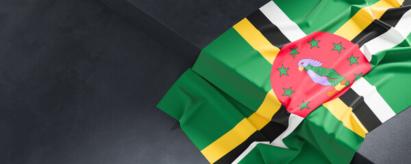 Flag of Dominica. Fabric textured Dominica flag isolated on dark background. 3D illustration - 765525605