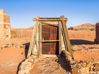 Lonely isolated door in the middle of a desert under the blue sky. Abadoned sandy bedouin village