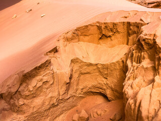 close up shot of sand flowing into a hole in the desert