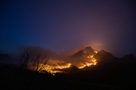 Mt Barney glowing with a line of fire over it