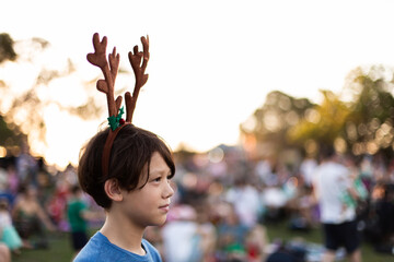 tween wearing reindeer antlers at the Christmas Carols
