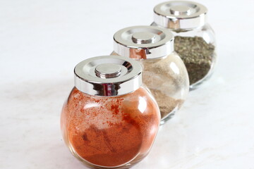 Glass Spice Jars with Ground Cayenne Pepper, Cardamom and Marjoram