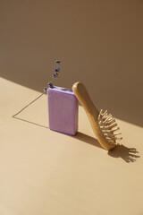 Wellness Eco comb and Lavender soap on beige background with spool of white cotton rope copy space...