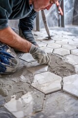 A man is laying tiles on the floor. Suitable for construction and renovation projects