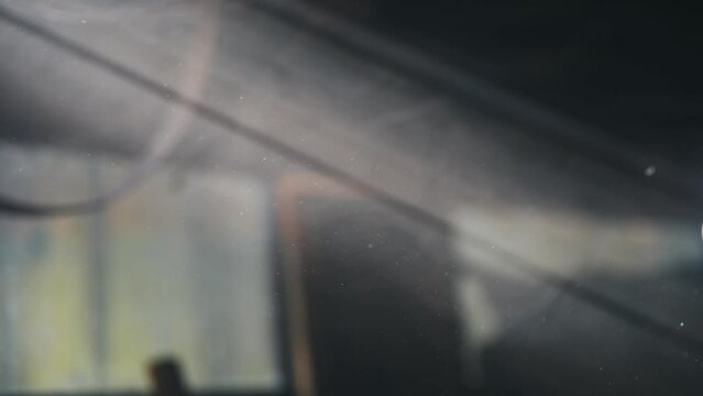 Supernatural bright beam of light fills the screen, the suns rays shine through the cracks, slow motion, camera movement