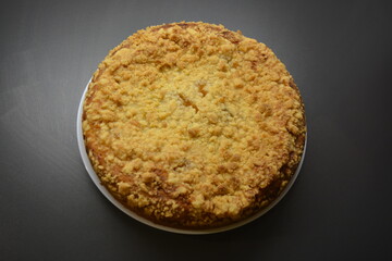 Kitchen, delicious homemade pie with pumpkin and apricot pieces placed on a white plate.