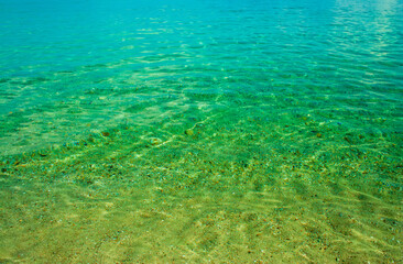Crystal clear blue and green sea waters at the beach.
