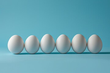 Five fresh white eggs arranged in a neat row on a vibrant blue background with space for text or design