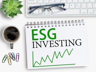 Fototapeta premium ESG investing results sign on notebook with keyboard and coffee,smartphone,glasses on office desk.