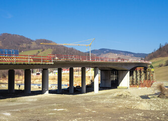 Construction of bridge over Poprad river on Polish and Slovakian border. Near Mnisek nad Popradom (Slovakia) and Piwniczna-Zdroj (Poland). View from Slovakian side.