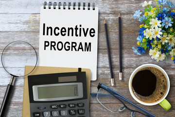 Incentive Program, Text on notebook in office desk workplace background.