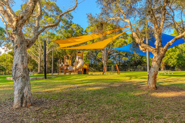 colourful Kids park with swings and slides yellow and blue shades in Suburban western Sydney NSW Australia