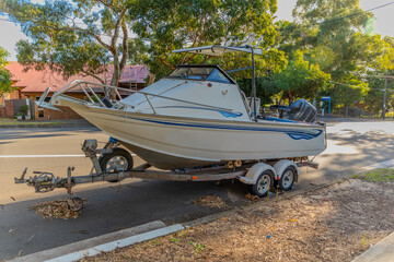 speed Boat Fishing Boat parked on the side of the road on a boat trailer in Western Sydney NSW Australia 