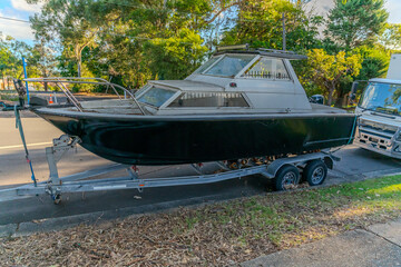speed Boat Fishing Boat parked on the side of the road on a boat trailer in Western Sydney NSW Australia 