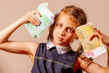 Money can't buy Your kids love. Young girl holding Euro money in her hands. Horizontal image.