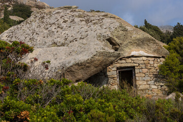 Traditonal anti pirate stone house with rock boulder roof on the remote Ikaria island in Greece.	
