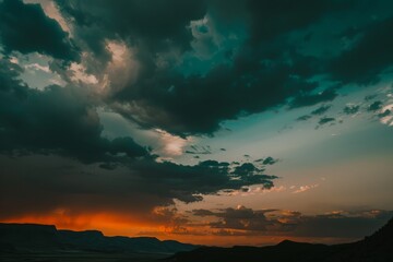 Obraz premium The sun dips below the horizon, casting a warm glow on the thick clouds filling the sky