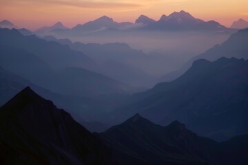 The sun sets behind a stunning mountain range, casting warm hues across the peaks and valleys as nightfall approaches