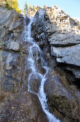 Fototapeta na wymiar small waterfall in the mountains