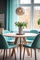 Turquoise chairs at round wooden dining table Interior design in mint style