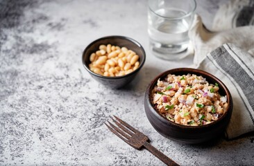 White beans red onion salmon salad in a bowl