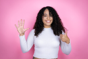 African american woman wearing casual sweater over pink background showing and pointing up with...