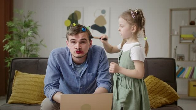 Multitasking Dad Gets Styled by Daughter While Working from Home