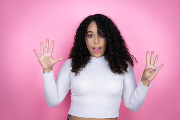 African american woman wearing casual sweater over pink background showing and pointing up with...