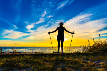 Nordic walking - beautiful woman exercising by the sea
- 765604625