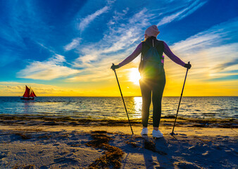 Nordic walking - beautiful woman exercising by the sea
- 765604651